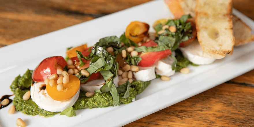 Fresh house made mozzarella with regionally grown tomatoes, pine nuts, basil, and pesto at Bin 22 in Jackson, Wyoming.