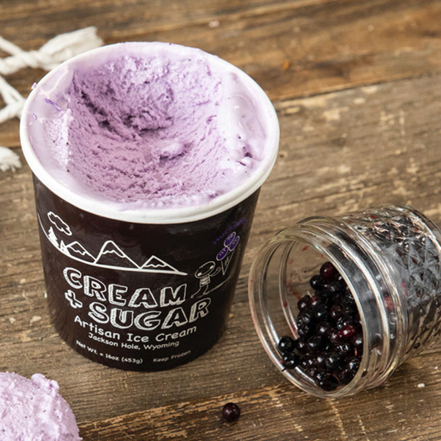 Pint of Cream + Sugar Huckleberry Ice Cream with a jar of fresh huckleberries at Bodega in Teton Village, Wyoming.