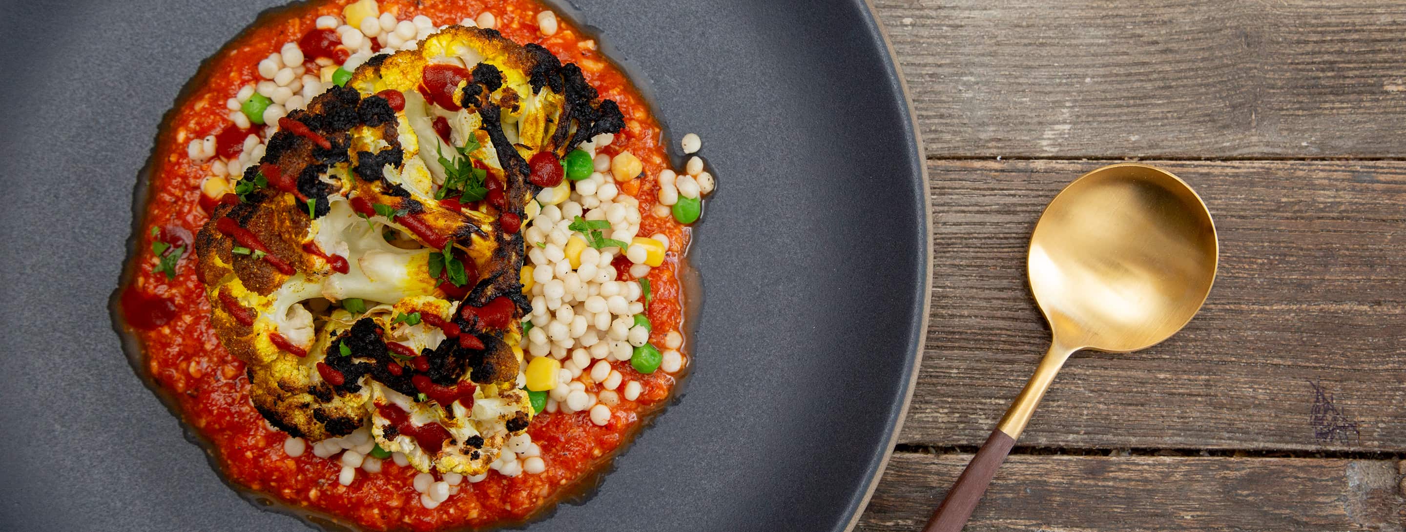Grilled cauliflower and gazpacho with couscous, corn and peas from Bistro Catering in Jackson, Wyoming.
