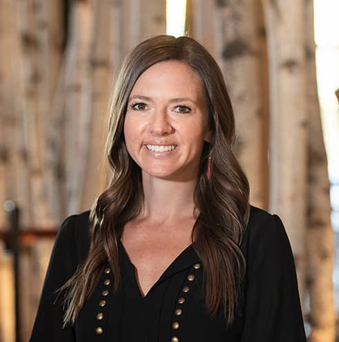 Portrait of Fine Dining Restaurant Group Director of Accounting, Megan Hopkins, in the dining room of The Bistro restaurant in Jackson, Wyoming.