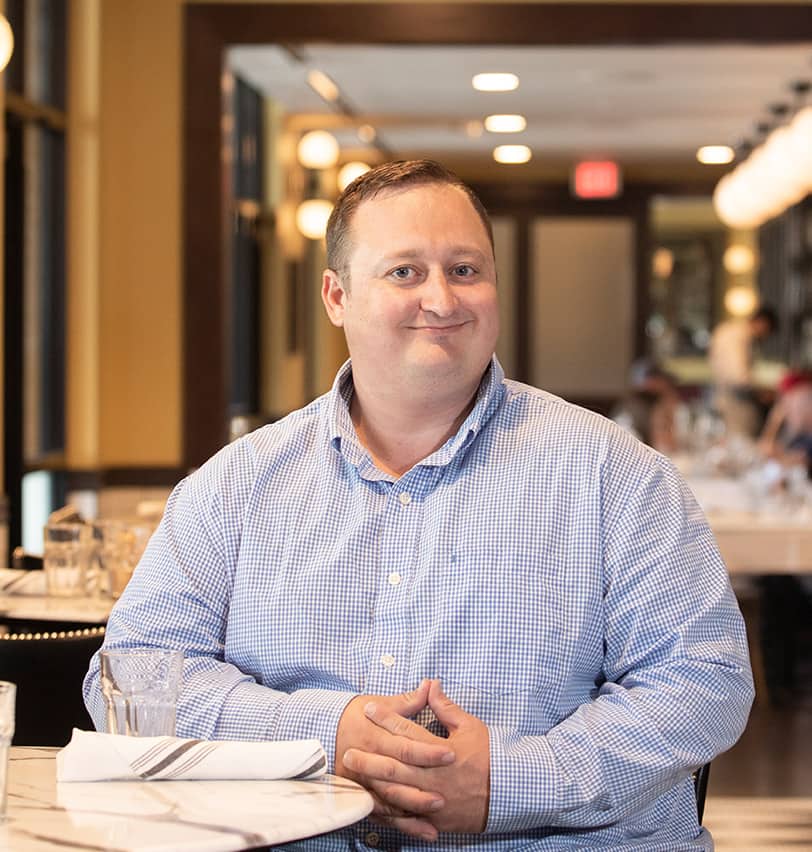 Portrait of Fine Dining Restaurant Group Director of Commissary Operations, Kevin Kunce, in the dining room of The Bistro restaurant in Jackson, Wyoming.