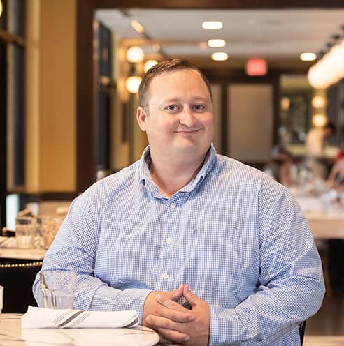 Portrait of Fine Dining Restaurant Group Director of Commissary Operations, Kevin Kunce, in the dining room of The Bistro restaurant in Jackson, Wyoming.
