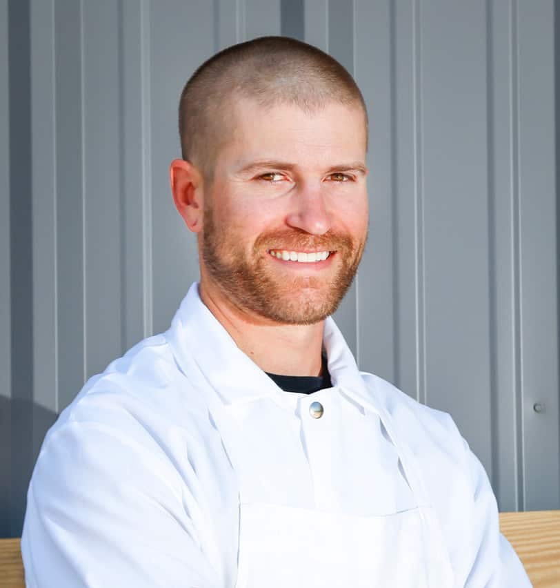 Portrait of Fine Dining Restaurant Group Vice President of Production for Bovine & Swine and Cream + Sugar, Joel Tate, outside a Fine Dining restaurant in Jackson.