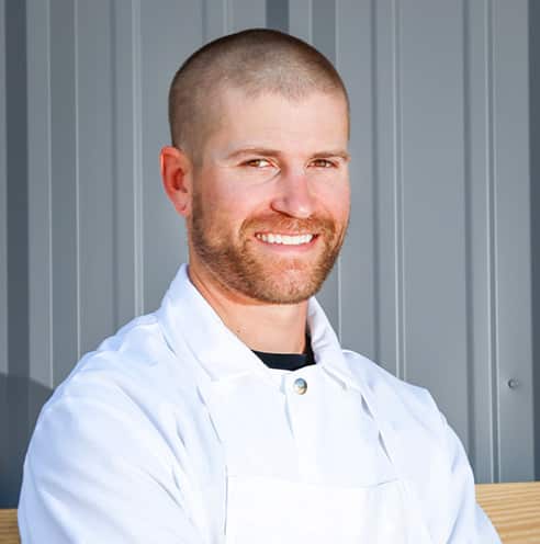 Portrait of Fine Dining Restaurant Group Vice President of Production for Bovine & Swine and Cream + Sugar, Joel Tate, outside a Fine Dining restaurant in Jackson.